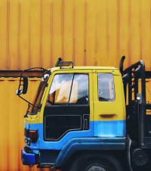 Yellow truck parked near a yellow container box